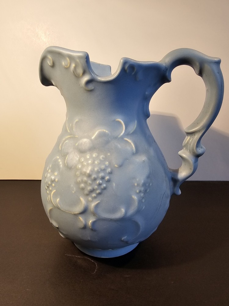 Blue Pitcher With Grapes And Leaves On The Side