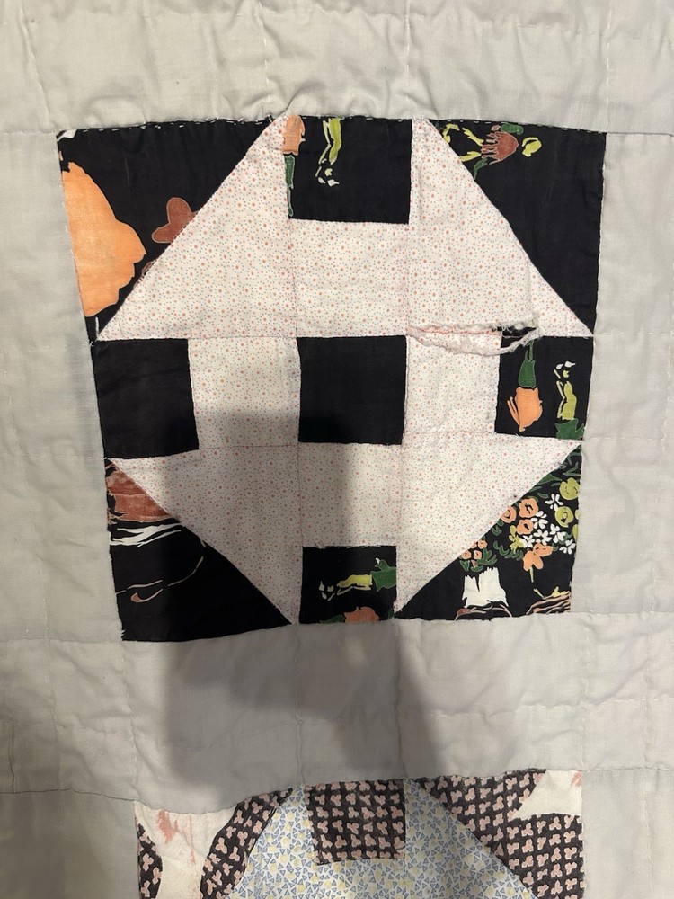 Cutters handmade scrappy patchwork quilt with varied fabric blocks.