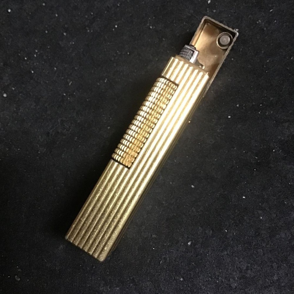 Overhauled gold dunhill lighter with striped pattern, ignition functioning well