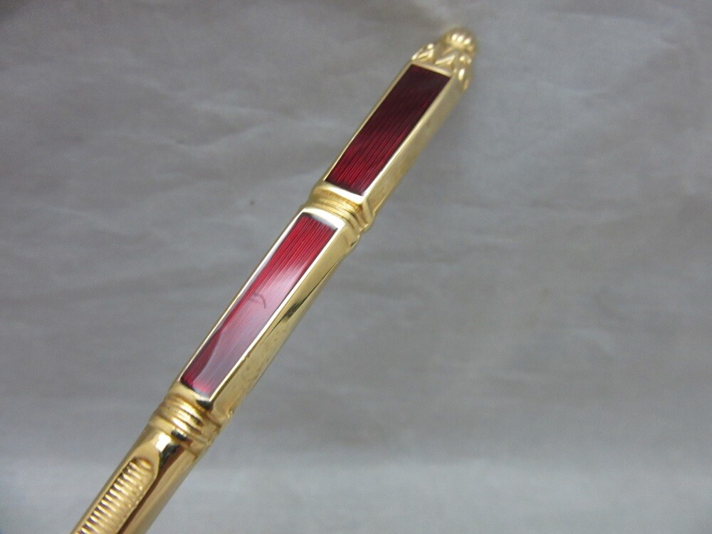 Gold plated cake server with red enamel handle