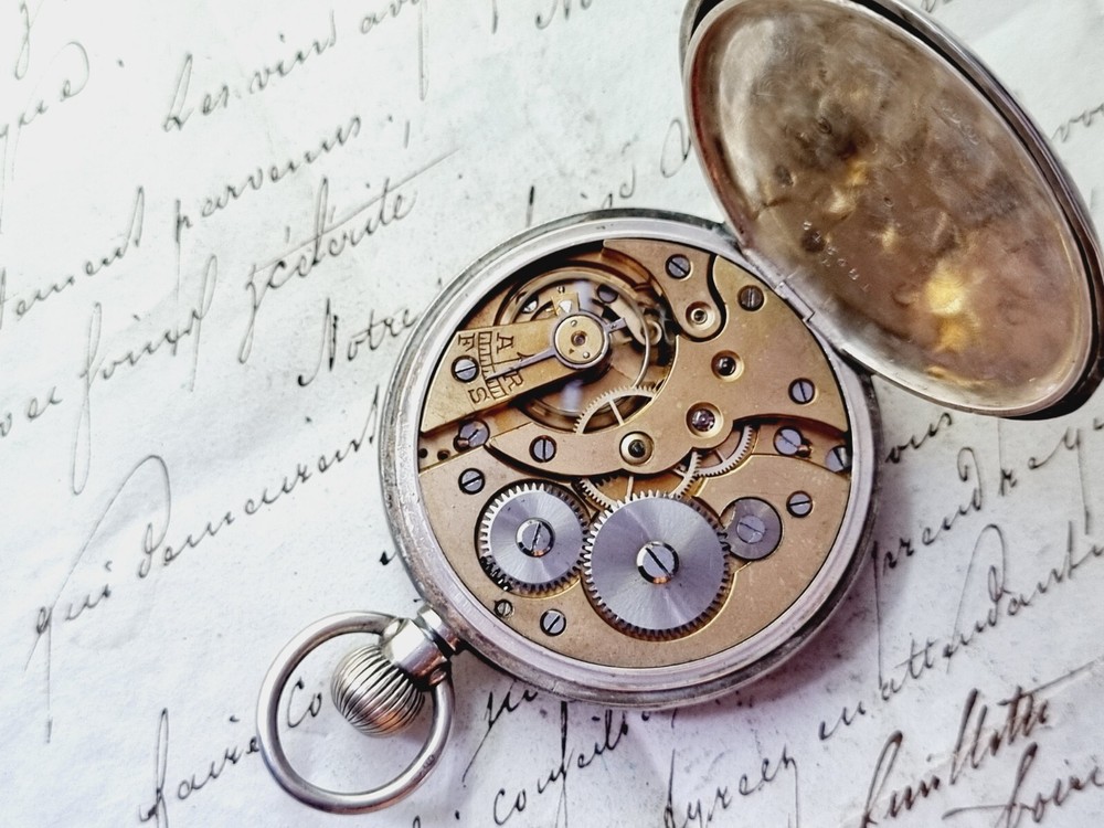 silver open face pocket watch