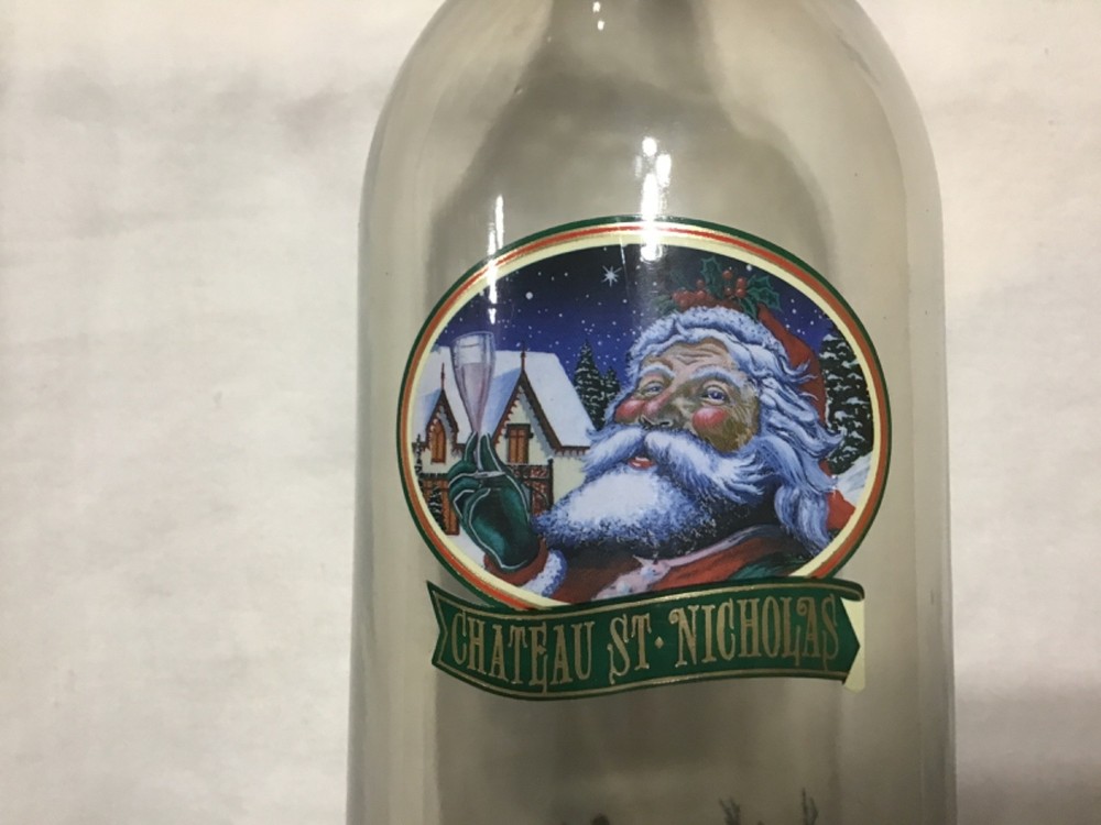 Christmas themed empty Chateau St. Nicholas wine bottle