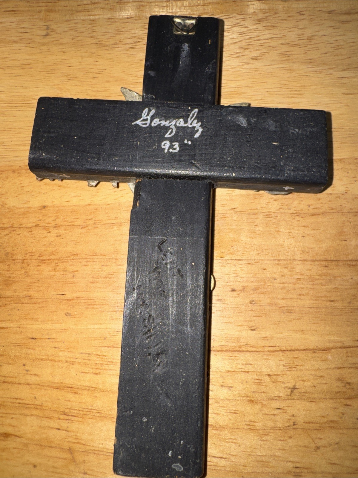 Vintage handmade folk art cross with 35+ brass milagros signed Gonzalez 1993