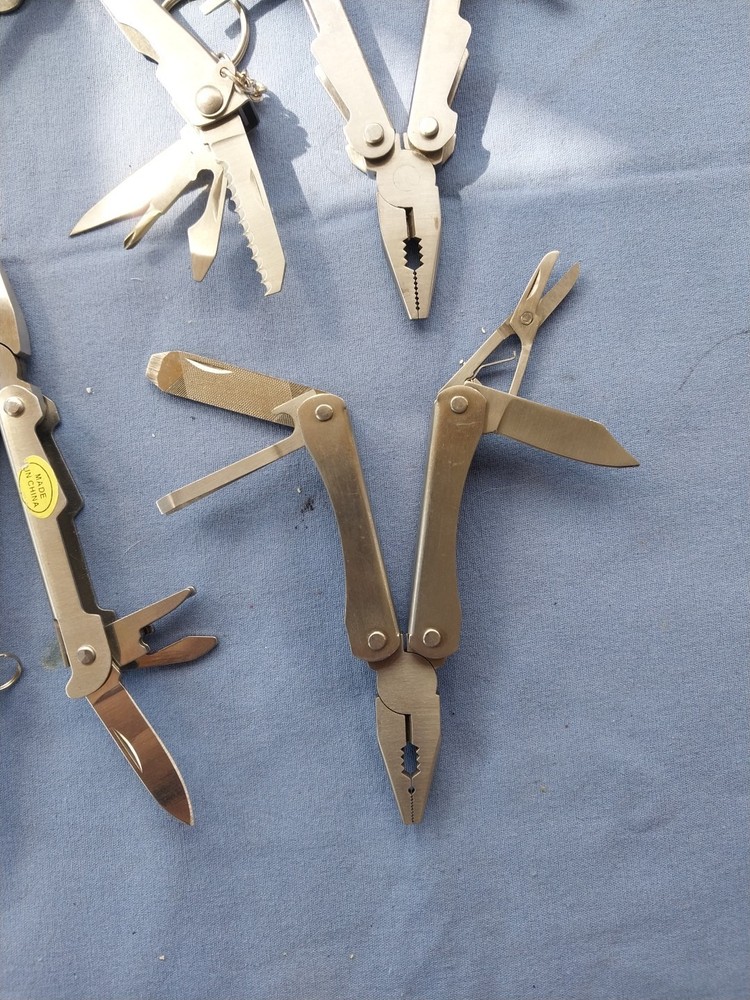 4 small multitudes with pliers knife scissors screwdriver's
