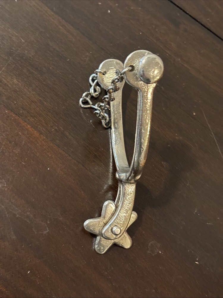 ONE UNMARKED SPUR - SILVER COLORED - SPINNING ROWEL