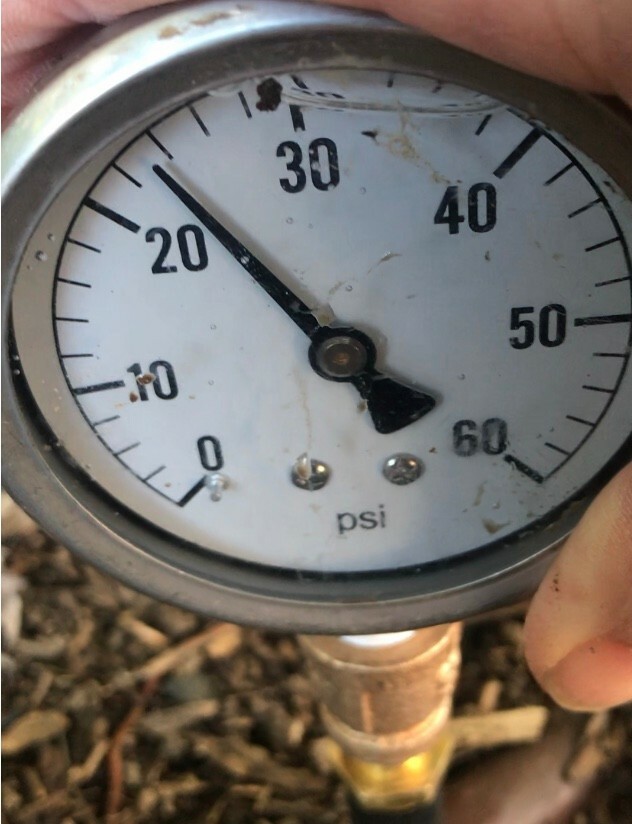 Drip irrigation pressure testing tool with 60 psi liquid filled gauge.