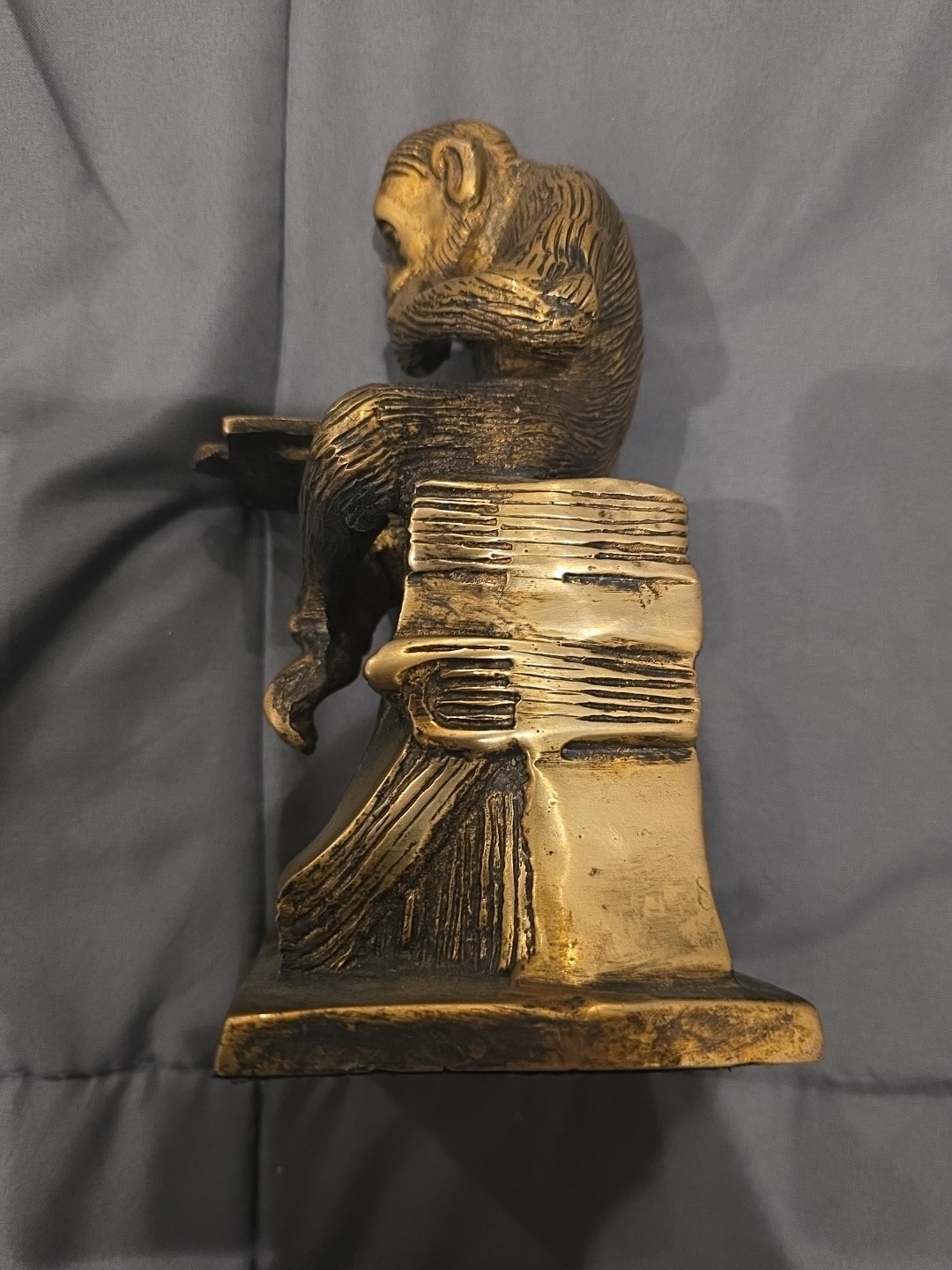 Bronze sculpture. Monkey with a book.