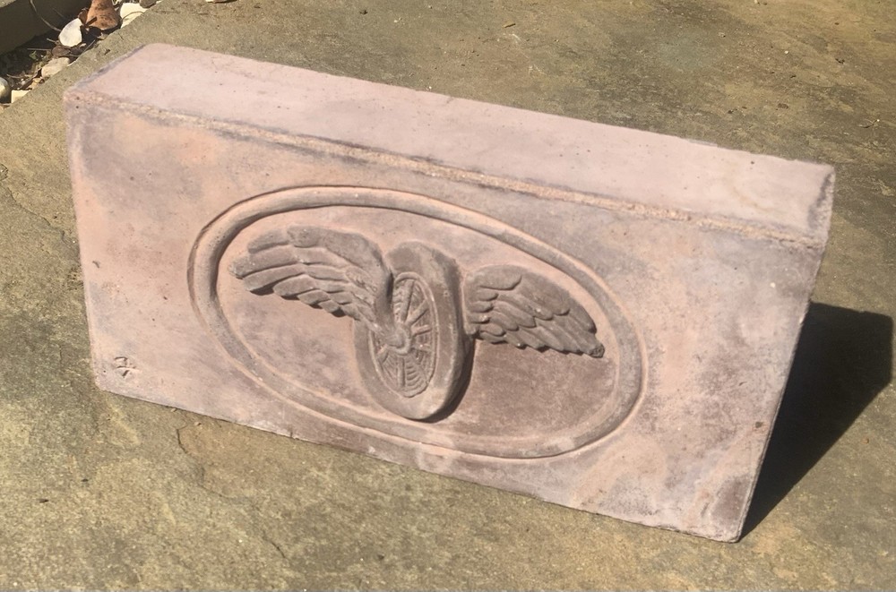 Brick With Winged Wheel Design