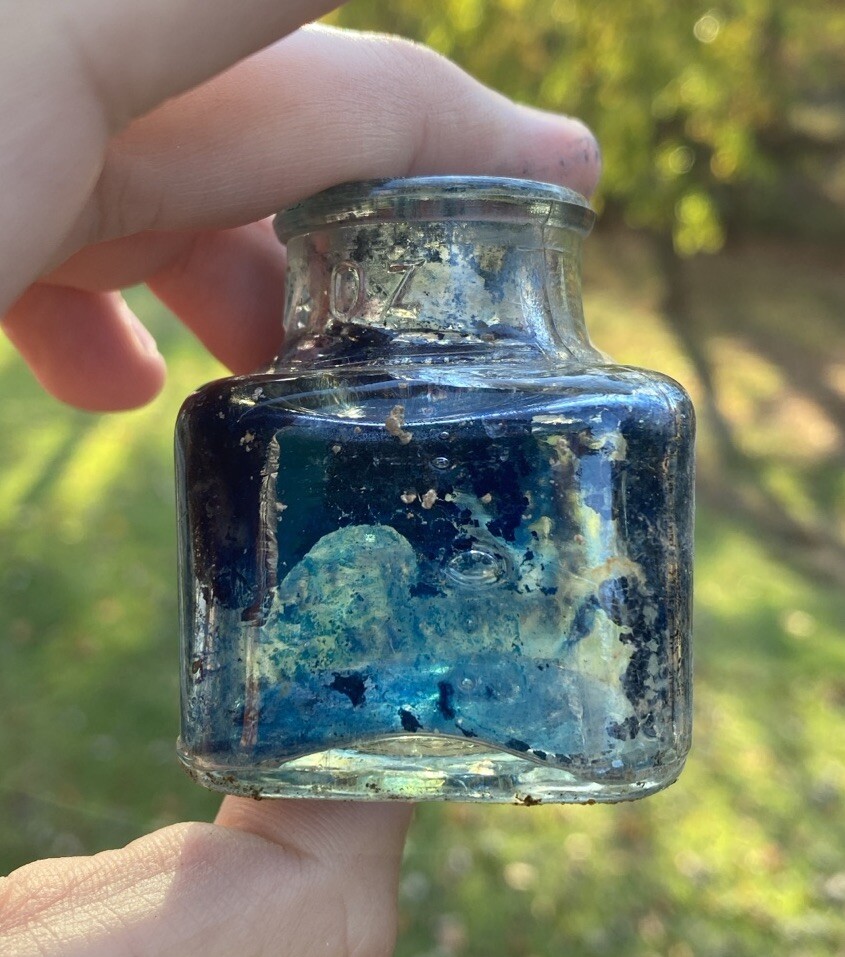 Clear Inkwell With Blue Ink And Partial Label
