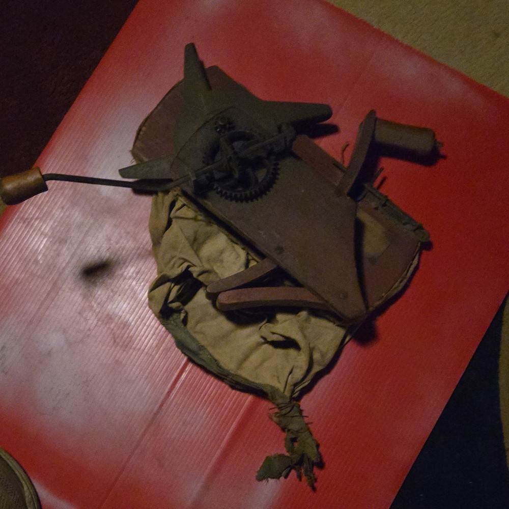 primitive hand-crank tool wood metal brown