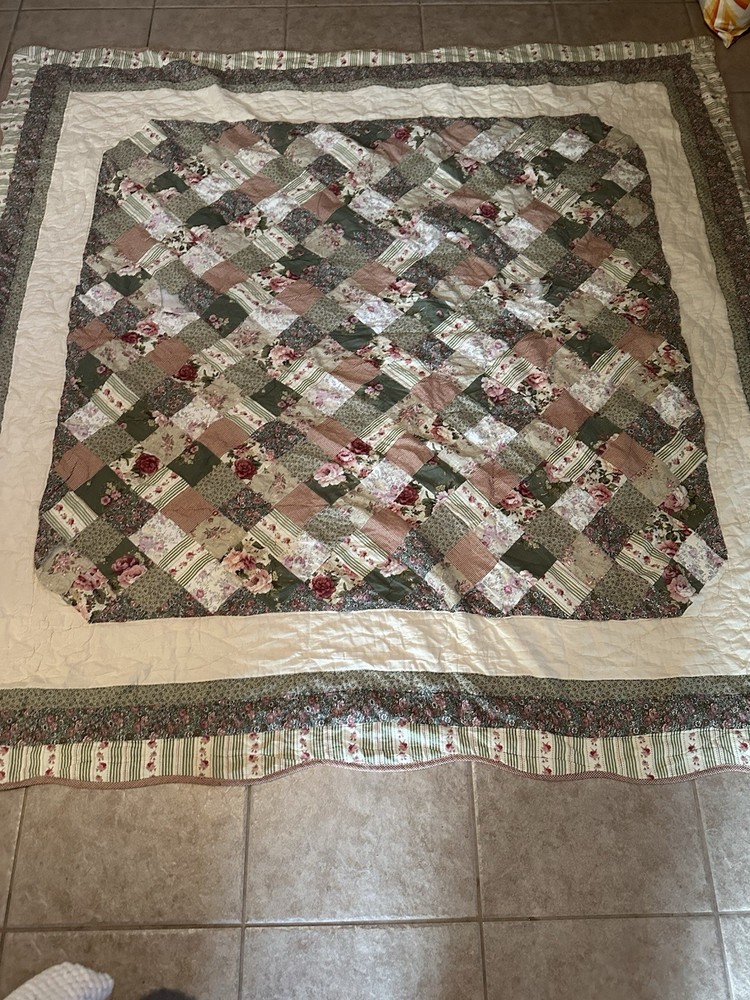 Cutters Handmade floral and striped patchwork quilt with diamond pattern.