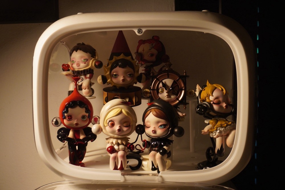 White display case with 17 Skillpanda figures. both in excellent condition