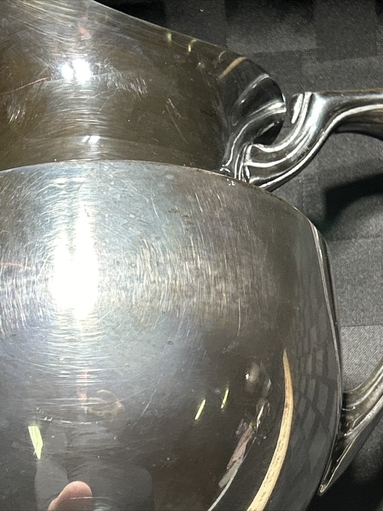 Vintage crescent silver plated water pitcher with ice lip