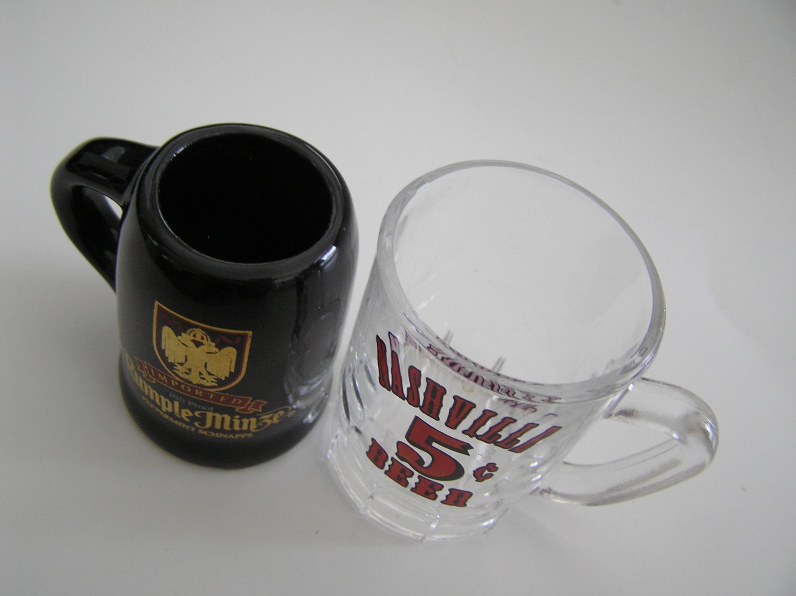 2 Souvenirs Shot Mugs: A Black Rumple Minze and A Clear Nashville 5cents Beer