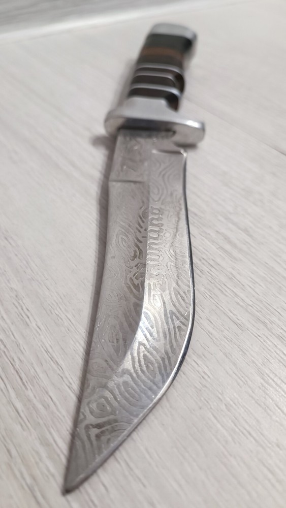 Antique handmade hunting knife with a pattern.