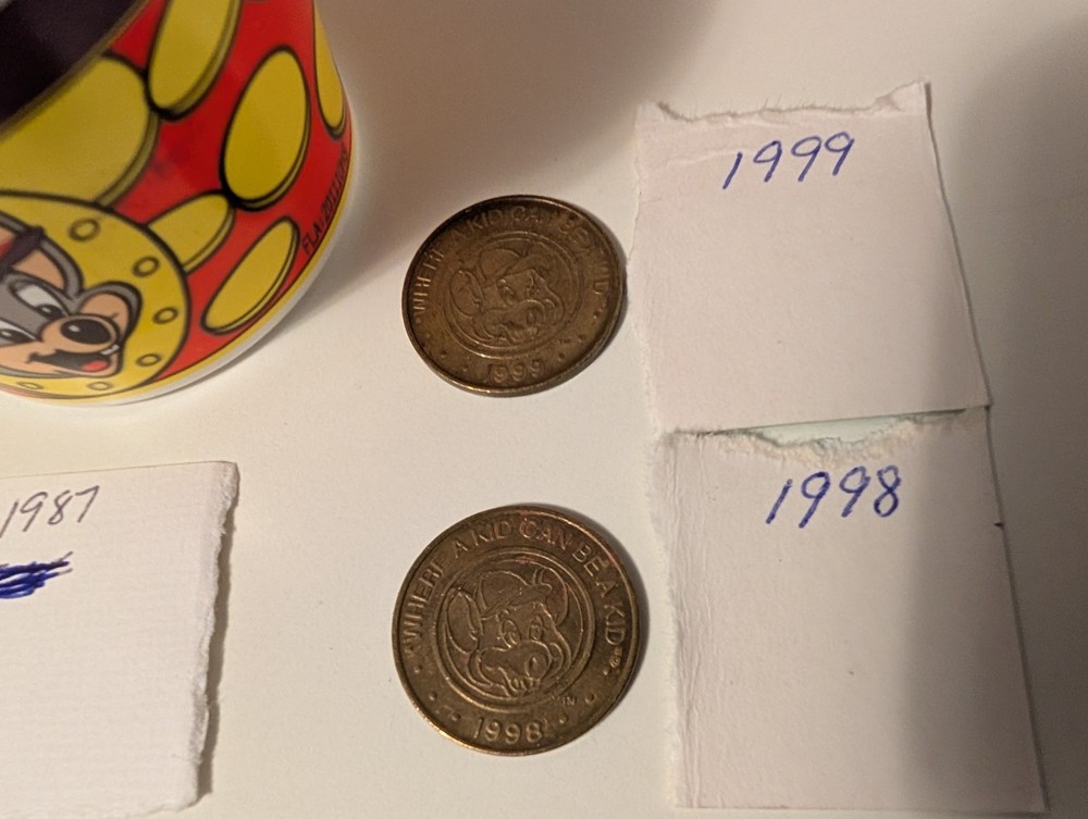 8. Old Chuck-E-Cheese Tokens And A Token Cup