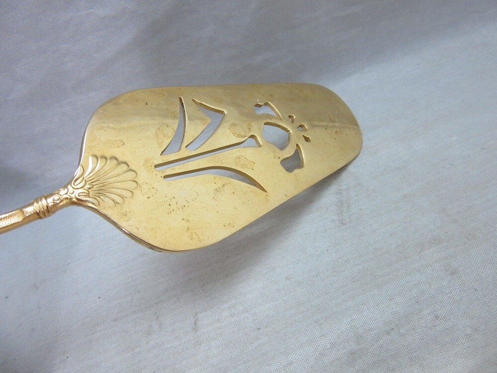 Gold plated cake server with red enamel handle