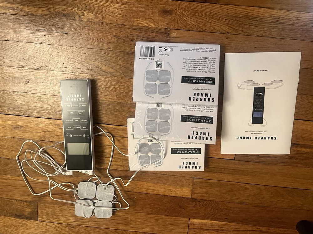Sharper image tens massager with handheld control plus extra pads