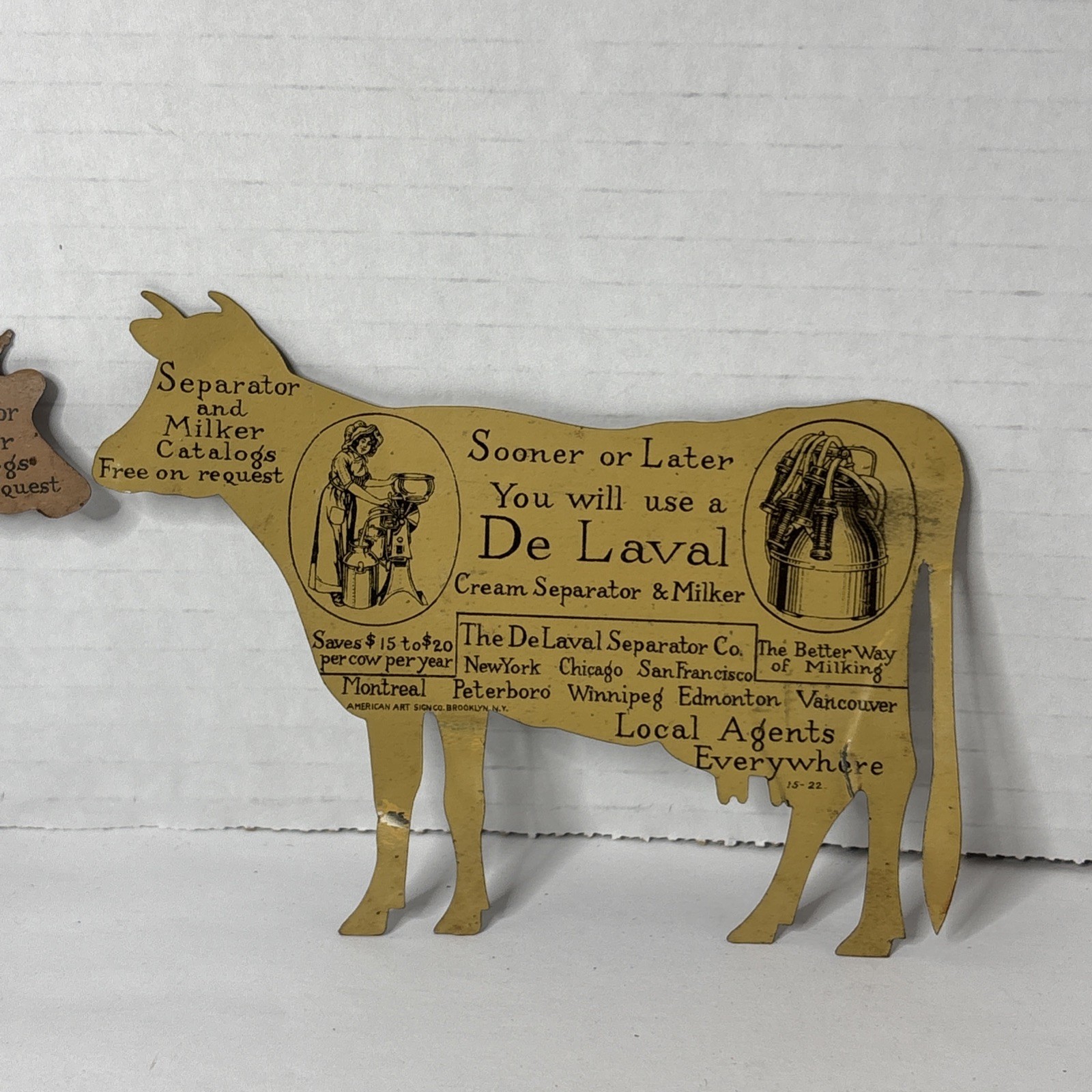 Pair of Antique DeLaval tin die cut cow and calf advertising cream separator ads