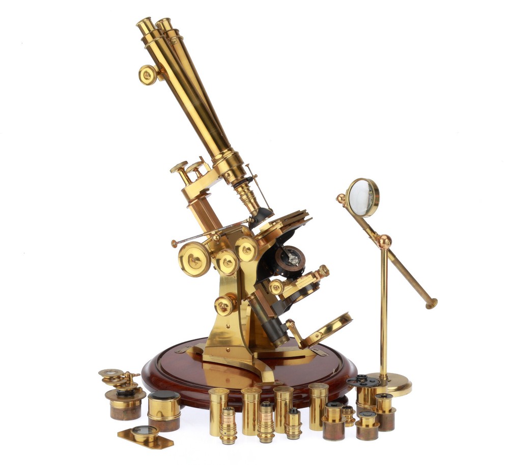 Very large binocular microscope in case with accessories.