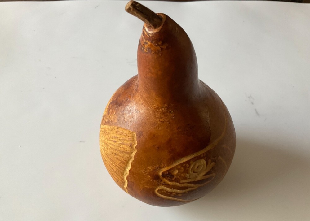 Decorative gourd etched with fish.