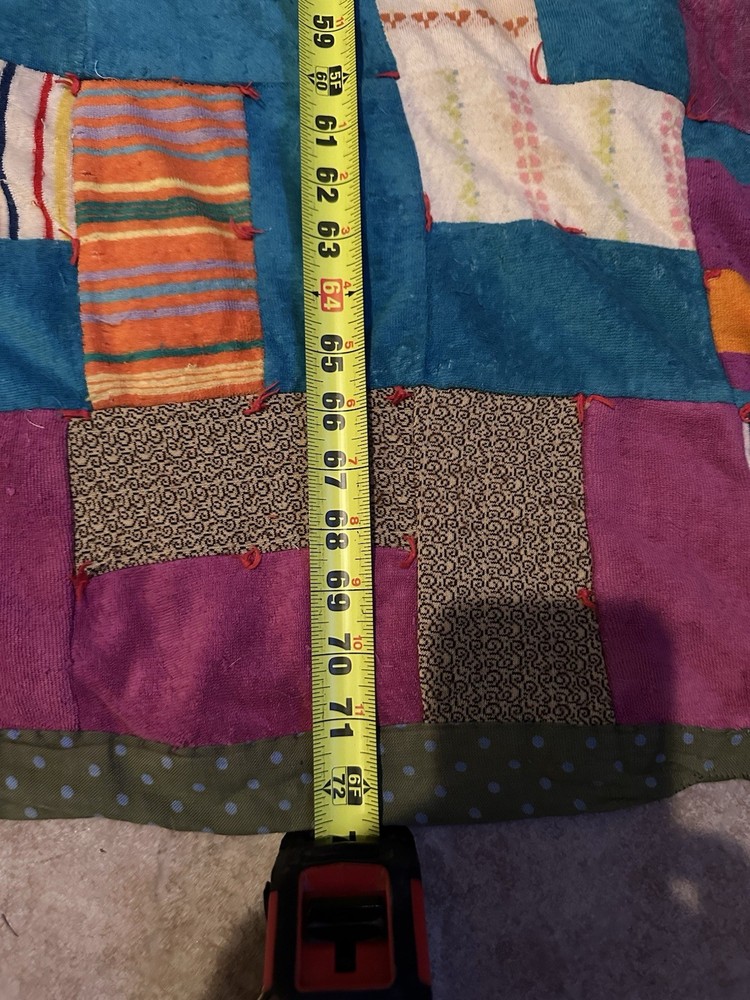 Handmade patchwork quilt with geometric 'L' block pattern.