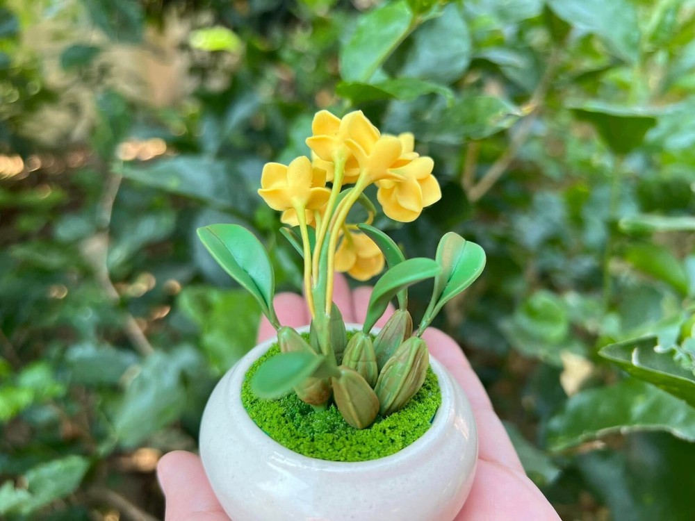 Tiny yellow orchids made by hand from clay