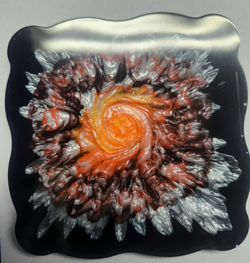 Orange, white and yellow on black coaster