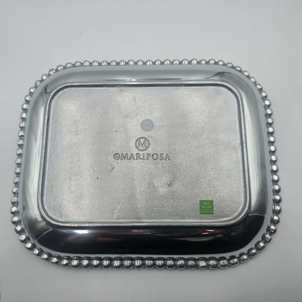 Rectangular platter with beaded edge. Made from recycled aluminum. Imported.