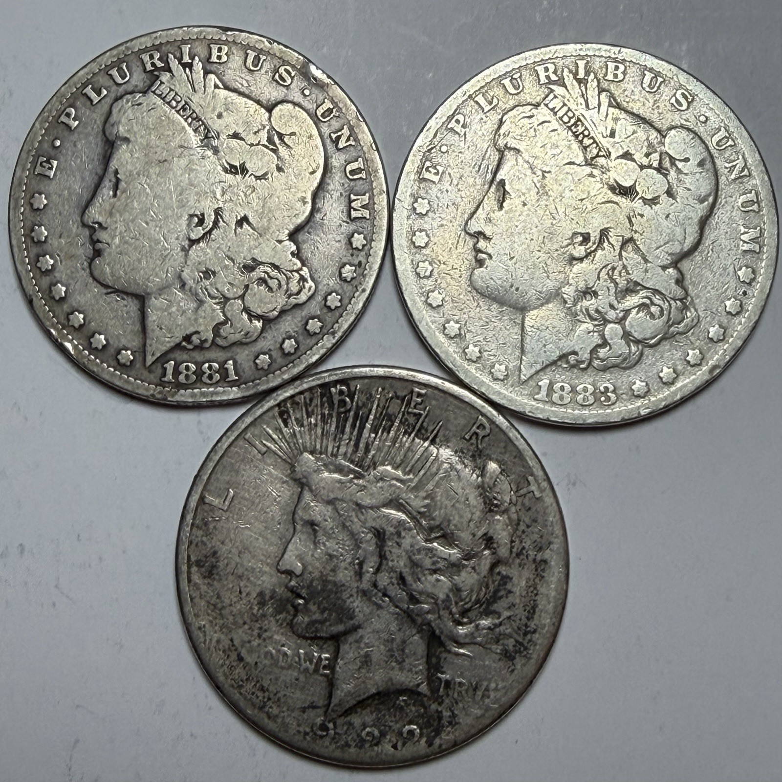 3 Silver Dollar Lot - 1881 O Morgan, 1883 Morgan, 1922 Peace