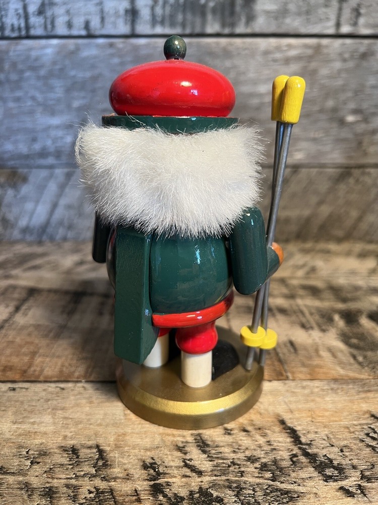 Vintage Christmas Nutcracker Holding Skies