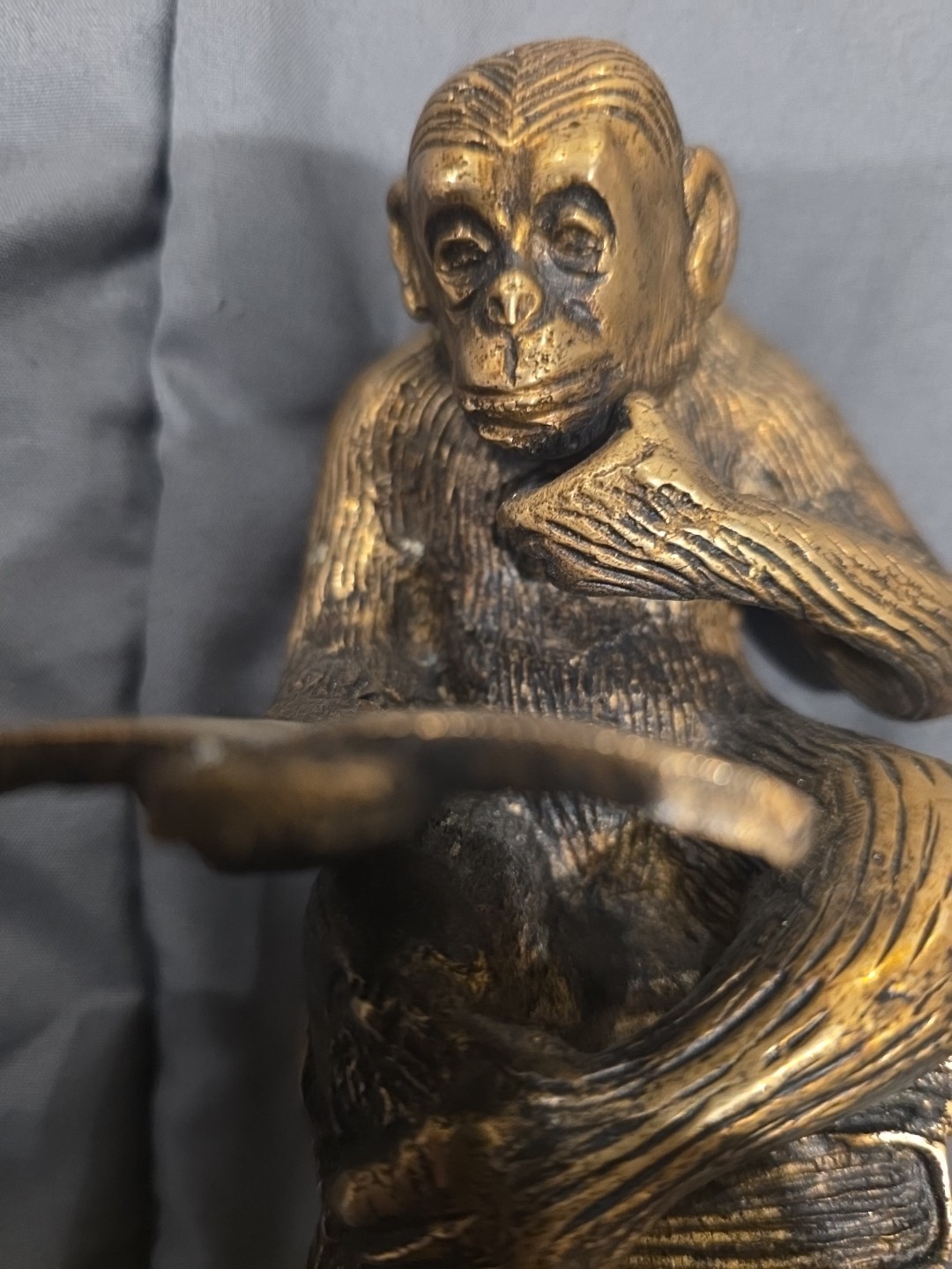 Bronze sculpture. Monkey with a book.