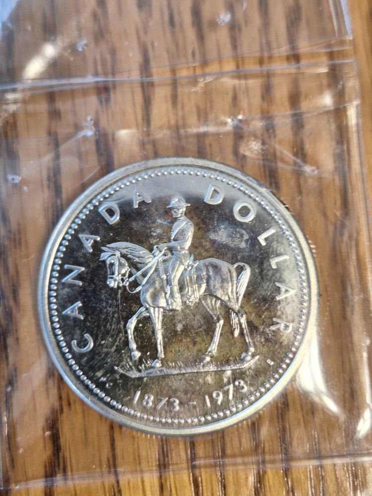 Rainbow Toned 1973 Canada RCMP Uncirculated Silver Dollar