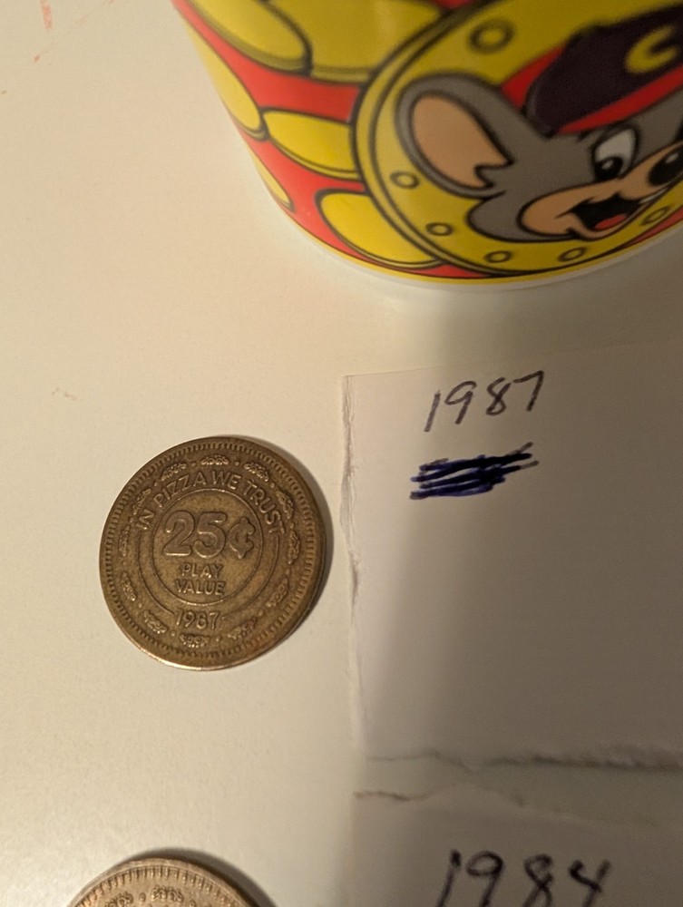 8. Old Chuck-E-Cheese Tokens And A Token Cup