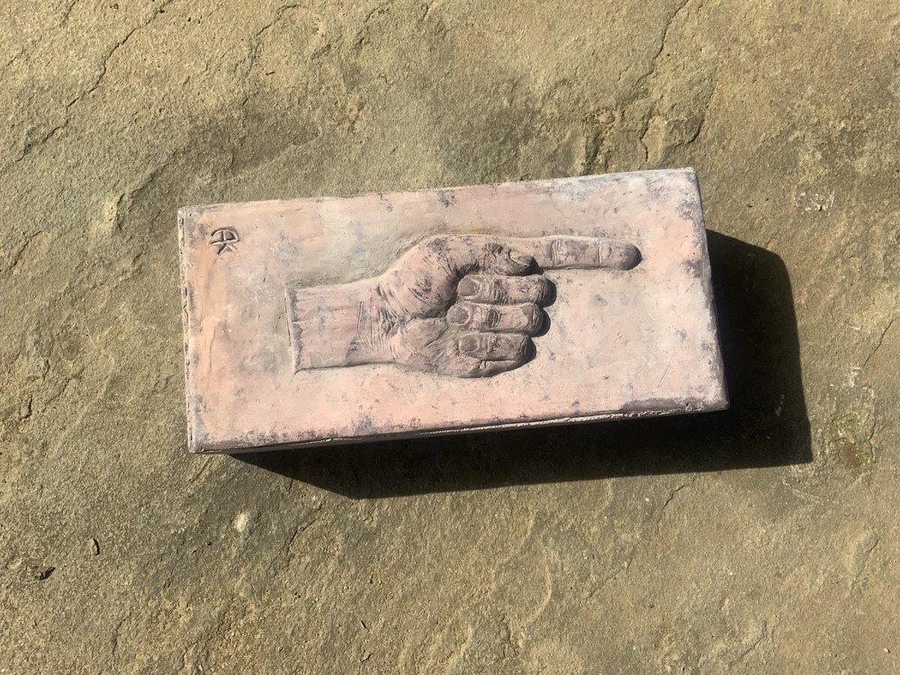 Brick With Pointing Hand