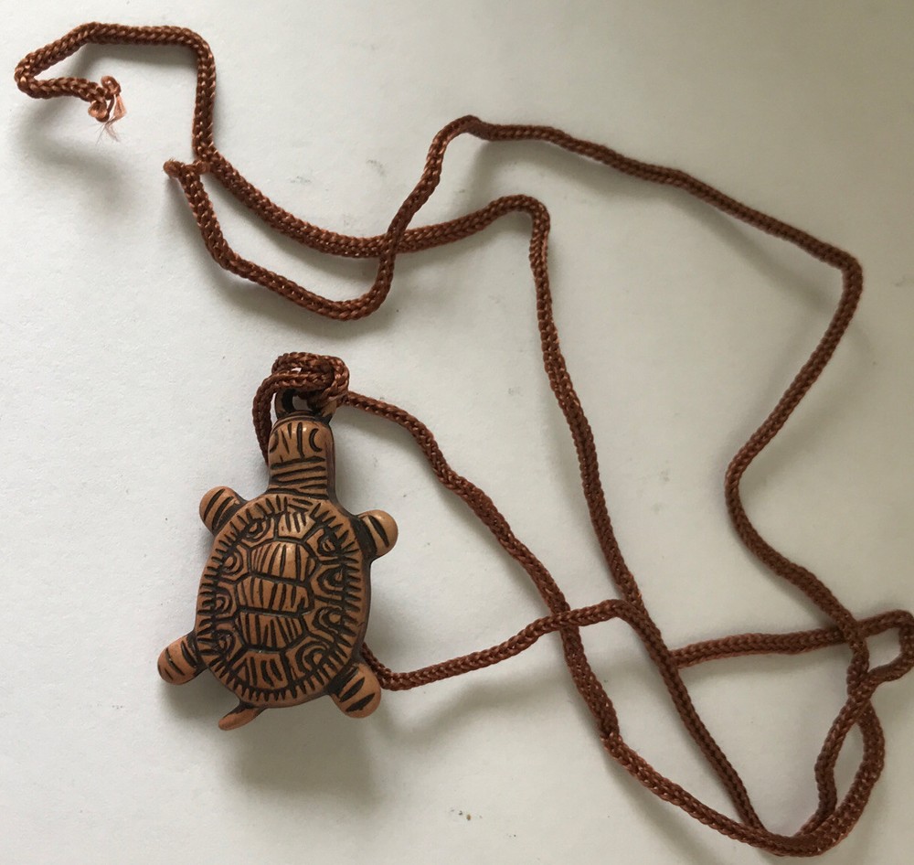 Resin turtle pendant with adjustable rope chain.