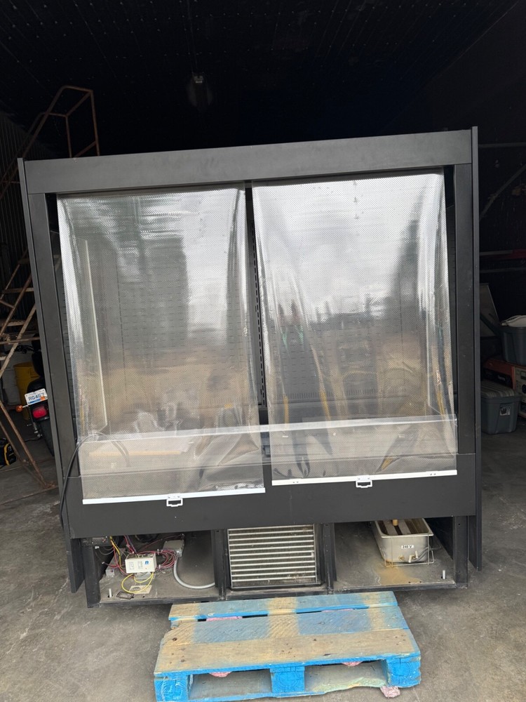 USED True commercial deli refrigerator with pull down screen doors.