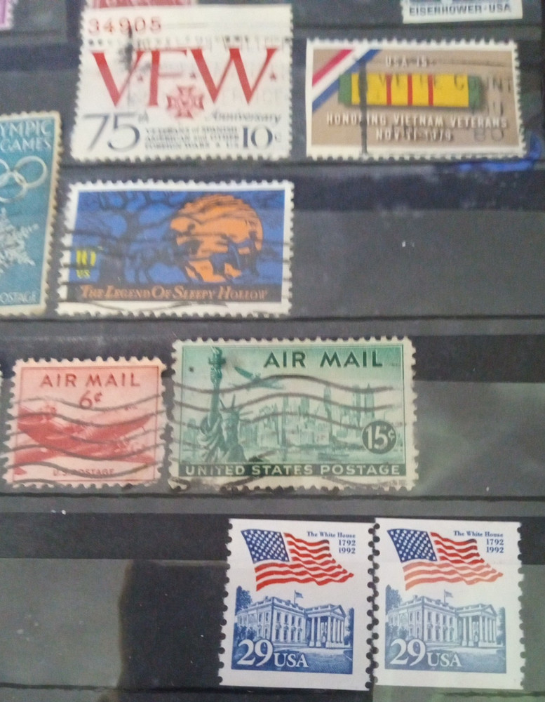 2" 3 ring binder w/ 5 pages of stamps over 100 usable stamps mostly US