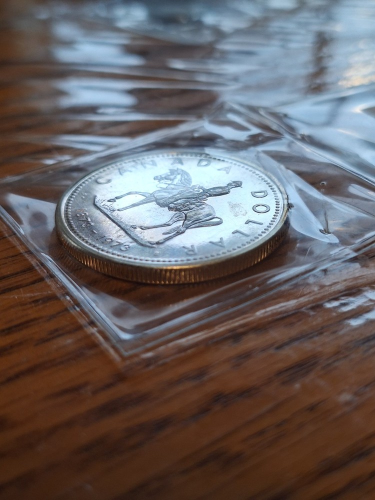 Rainbow Toned 1973 Canada RCMP Uncirculated Silver Dollar