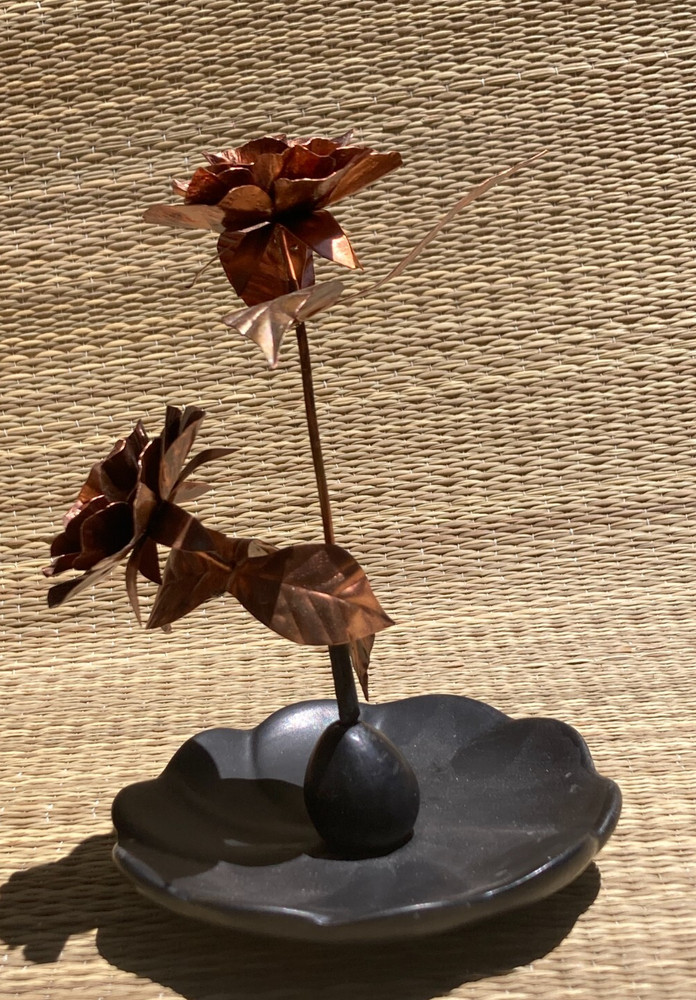 Beautiful copper 'orange' roses with leaf on ceramic base