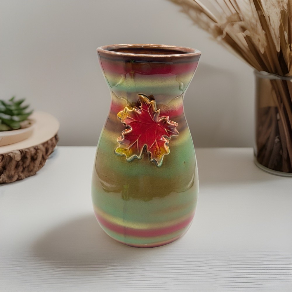 Stunning/9”/ceramic vase with a maple leaf design and a metallic glaze.