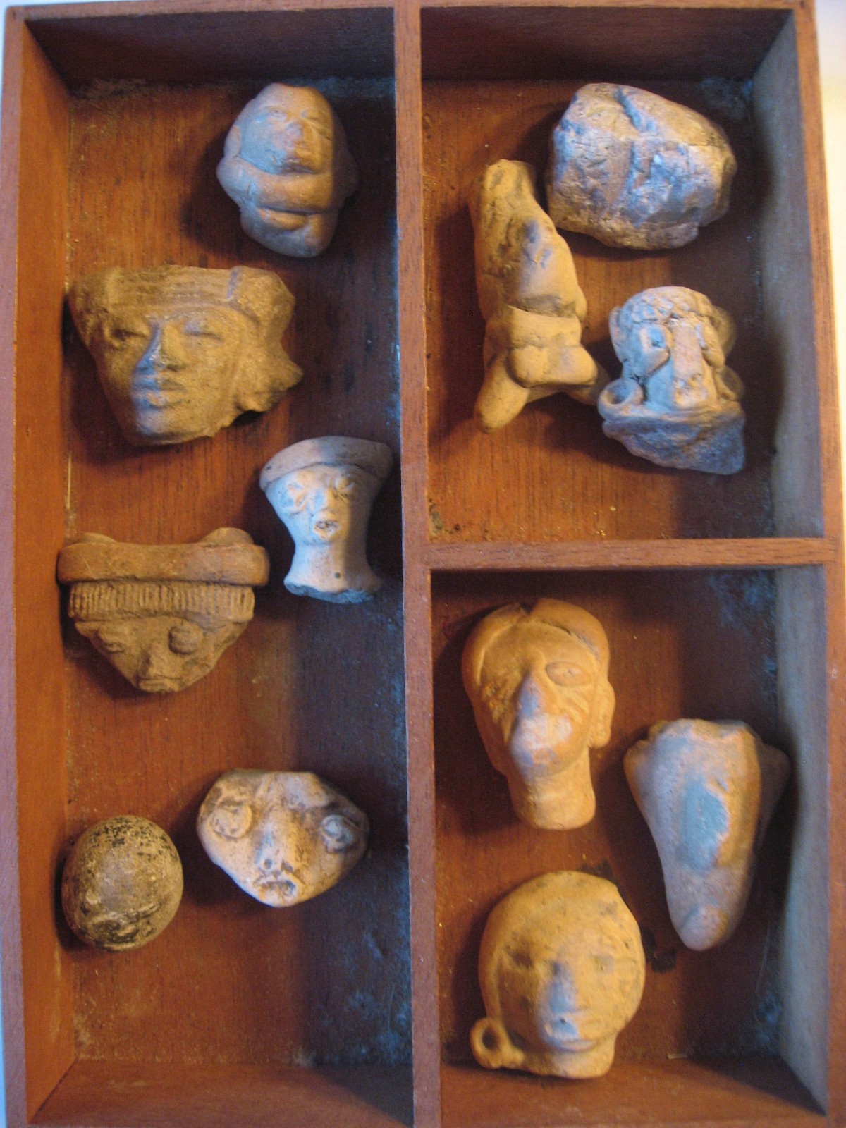 Antique Pre-Columbian Artifacts Box of 12 Hand Carved Stone Face Heads on Wood