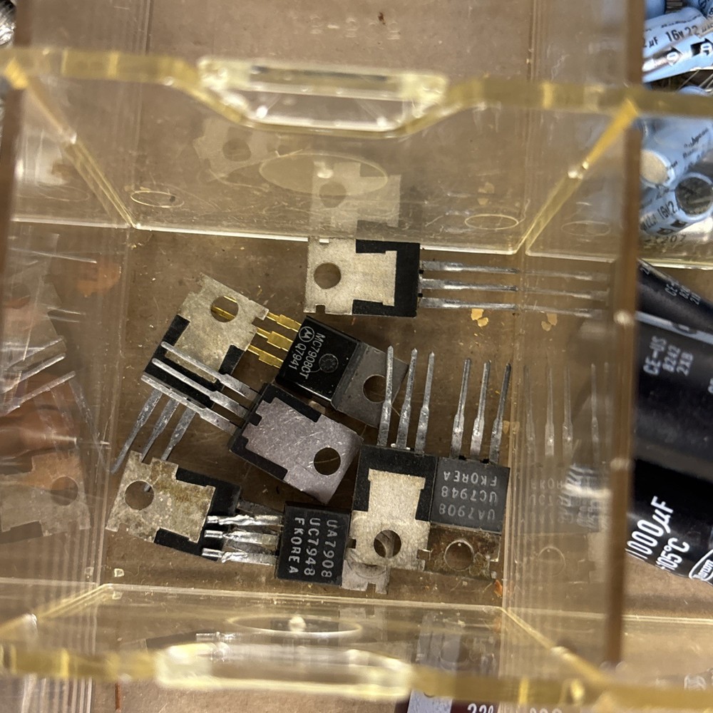 assorted electronics components, parts in a compartment box, NOS capacitors, etc