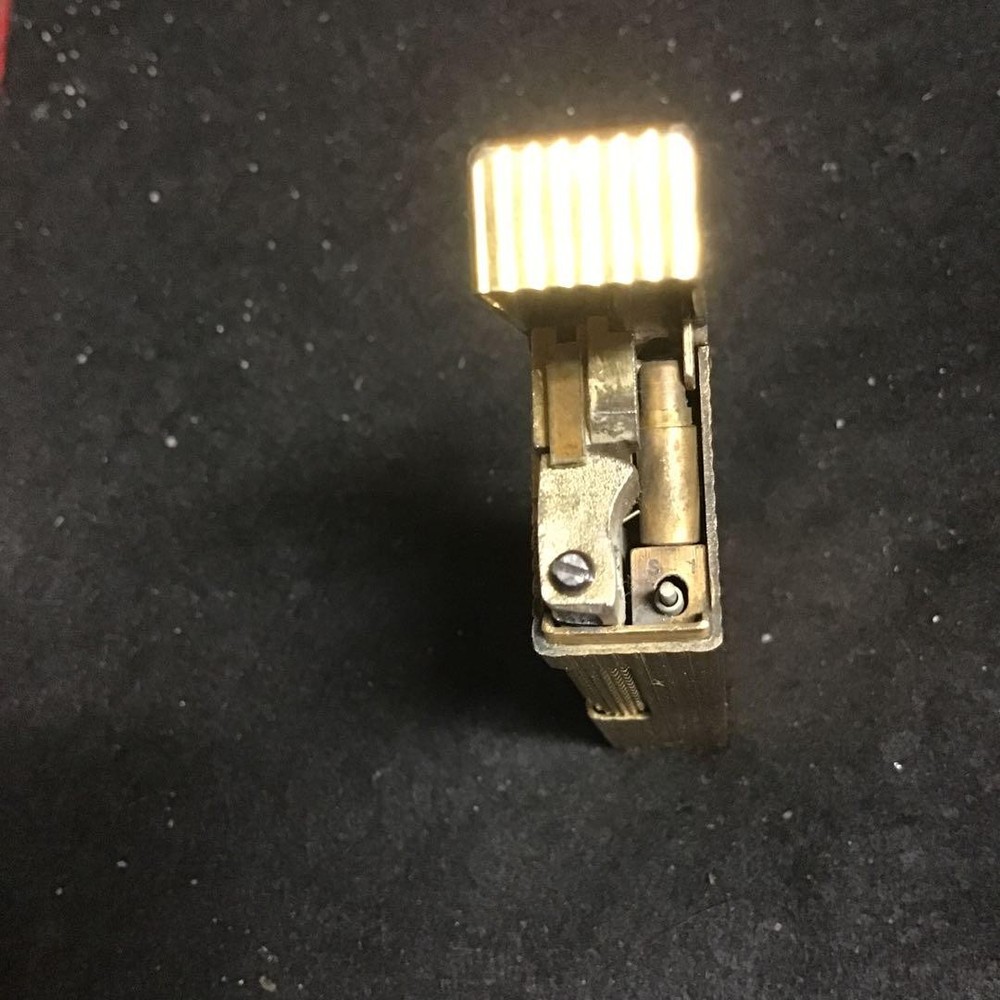 Overhauled gold dunhill lighter with striped pattern, ignition functioning well