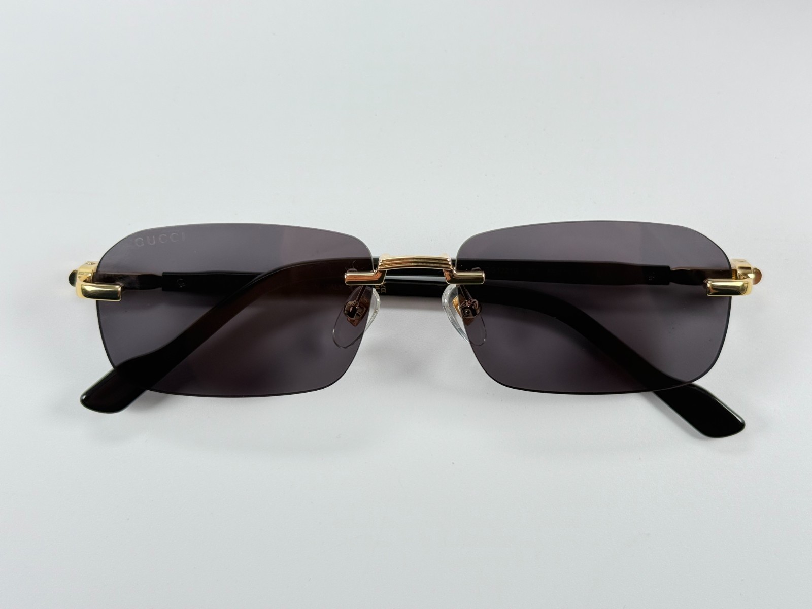 Gucci GG1221S 001 Black Gold Rimless Sunglasses Gray Lens 56mm
