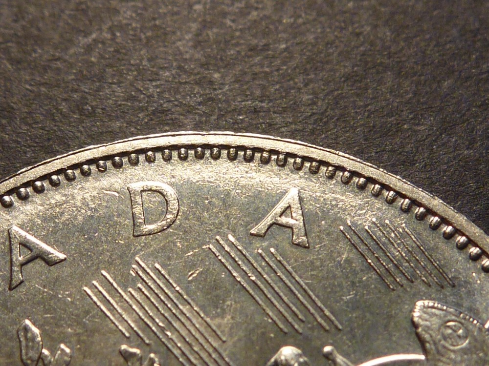 Error: Canada 1982 BU Voyageur nickel $1 with strike-through errors both sides