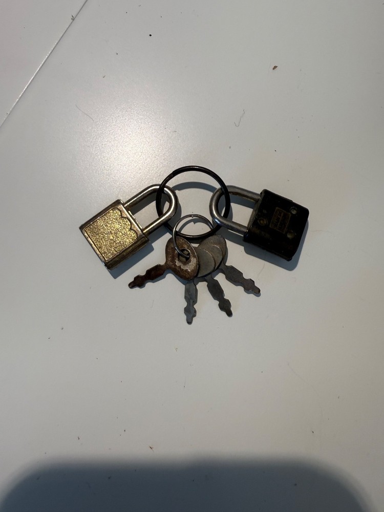 Two small luggage locks with four keys