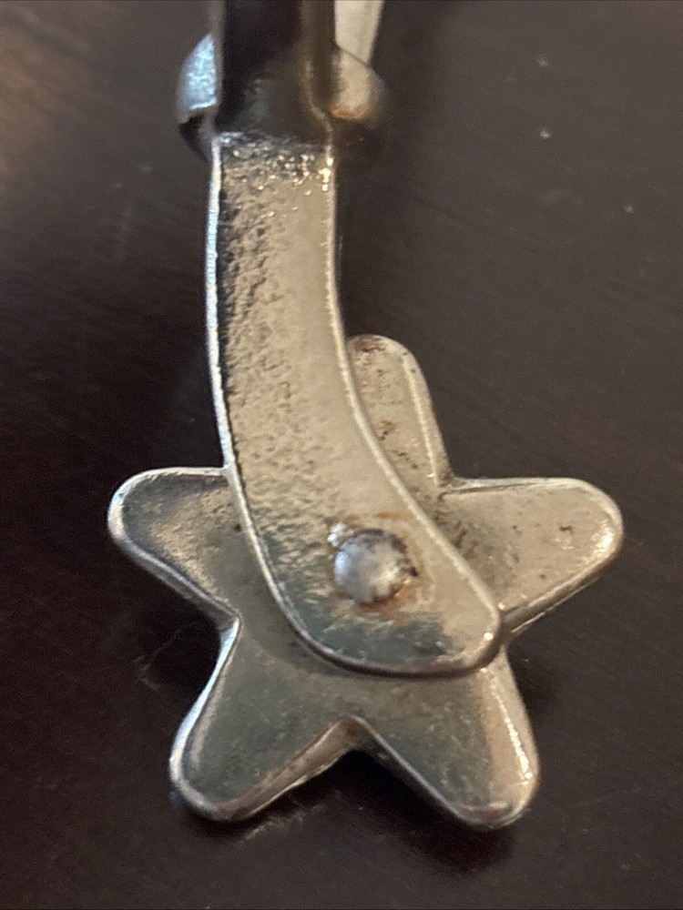 ONE UNMARKED SPUR - SILVER COLORED - SPINNING ROWEL