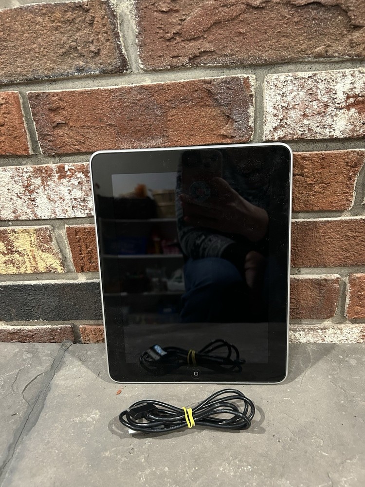 first-generation Apple iPad with a 30-pin charging cable