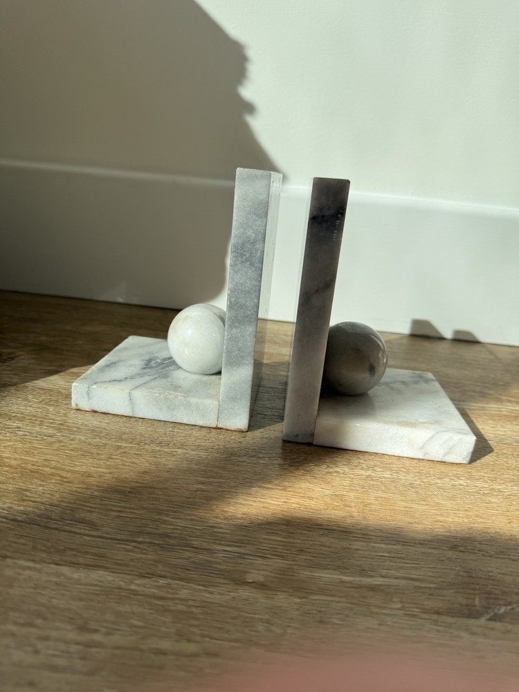 Vintage marble bookends with spherical elements.